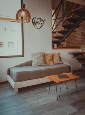 a living room with a couch and a table at Pentagrama, casas de campo in Villa General Belgrano