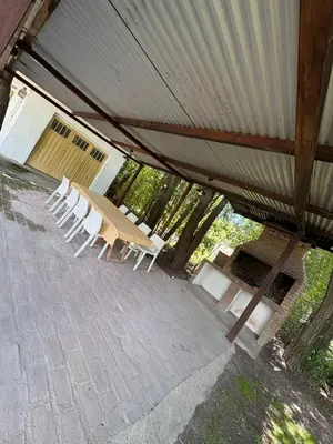 a group of white chairs sitting under a tent at Él Algarrobo in San Antonio de Arredondo