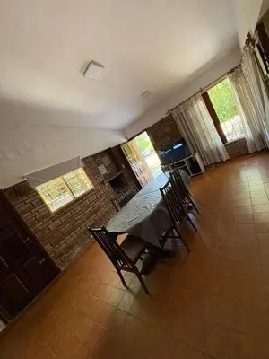 a dining room with a table and chairs at Él Algarrobo in San Antonio de Arredondo