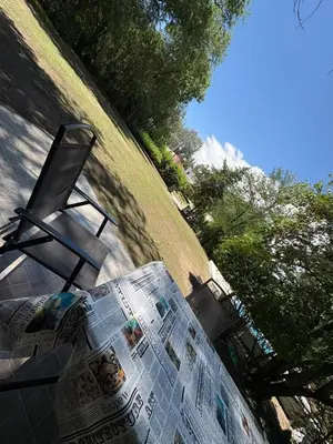 a newspaper laying on the ground next to a chair at Él Algarrobo in San Antonio de Arredondo