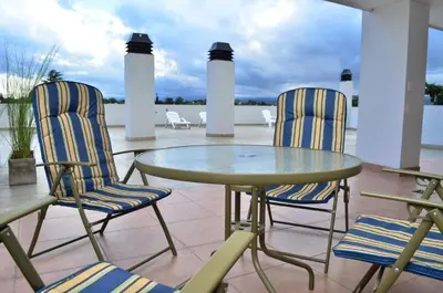 two chairs and a glass table on a patio at Departamento centrico Villa Carlos Paz in Villa Carlos Paz
