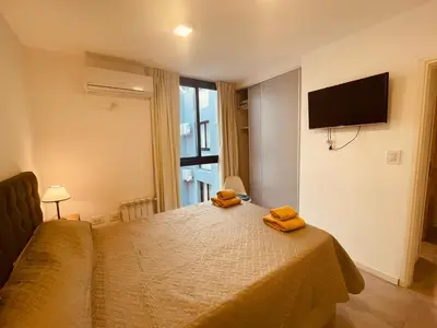 a bedroom with a bed with two towels on it at Departamento centrico Villa Carlos Paz in Villa Carlos Paz