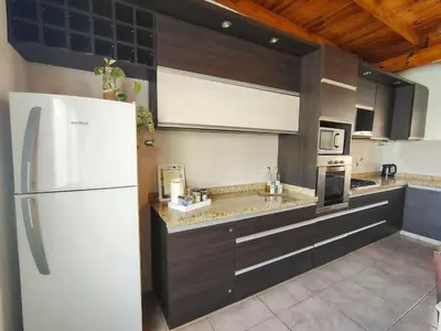 a kitchen with a white refrigerator and a stove at Depto Viamonte PlantaAlta, 2Dorm, Terraza, Cochera in Cordoba