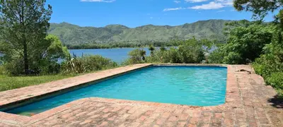a swimming pool with a view of a lake at La Calma Casa de Campo - Villa Parque Siquiman in Villa Parque Siquiman