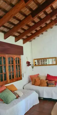 a bedroom with two beds in a room at La Calma Casa de Campo - Villa Parque Siquiman in Villa Parque Siquiman