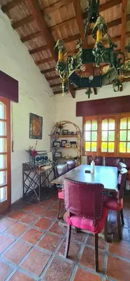 a dining room with a table and chairs at La Calma Casa de Campo - Villa Parque Siquiman in Villa Parque Siquiman