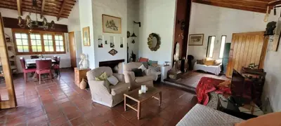a living room with couches and a table at La Calma Casa de Campo - Villa Parque Siquiman in Villa Parque Siquiman