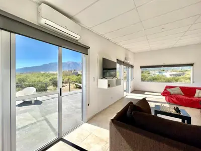 a living room with a couch and a large window at Anubis in Merlo