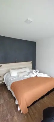 a bedroom with a large bed with a headboard at Anubis in Merlo