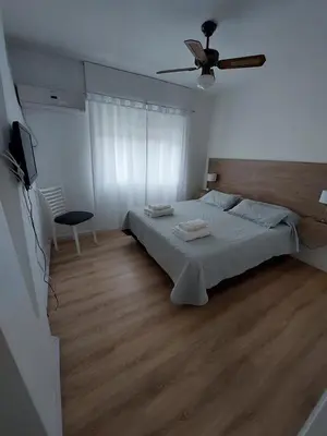 a bedroom with a bed and a ceiling fan at FRANCISMAR - Cálido Depto. Centro Carlos Paz in Villa Carlos Paz