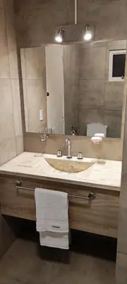 a bathroom with a sink and a large mirror at FRANCISMAR - Cálido Depto. Centro Carlos Paz in Villa Carlos Paz