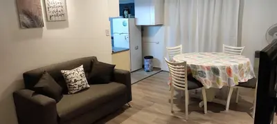 a living room with a couch and a table with chairs at FRANCISMAR - Cálido Depto. Centro Carlos Paz in Villa Carlos Paz
