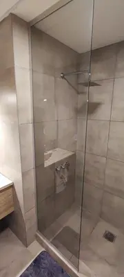 a shower with a glass door in a bathroom at FRANCISMAR - Cálido Depto. Centro Carlos Paz in Villa Carlos Paz