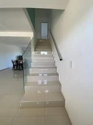 a staircase in a house with a glass wall at Villaloma in Villa Carlos Paz