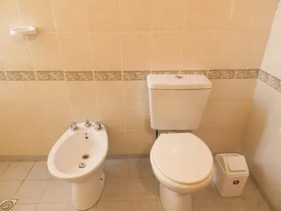 a bathroom with a toilet and a bidet at Descanso Serrano in Tanti