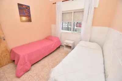 a bedroom with two beds and a window at Kaiken Maison in Villa Santa Cruz del Lago