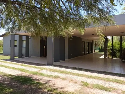 an empty building with a tree in the foreground at Campo sereno in Falda del Carmen