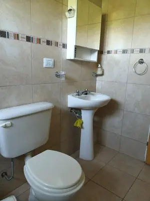 a bathroom with a toilet and a sink at Campo sereno in Falda del Carmen