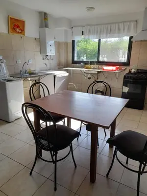 a wooden table and chairs in a kitchen at Campo sereno in Falda del Carmen