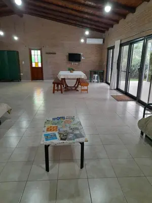 a large room with a table in a room with windows at Campo sereno in Falda del Carmen
