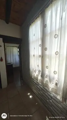 a room with a window with white curtains at El Espinillo, Casa de Campo in Santa Rosa de Calamuchita