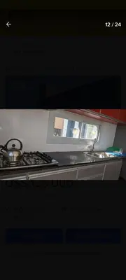 a kitchen with a sink and a stove top oven at Hermosa casa en Lomas Del Rey in San Antonio de Arredondo
