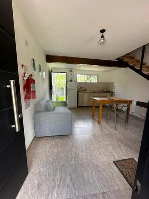 a living room with a couch and a table at Aromas del Valle in Santa Rosa de Calamuchita