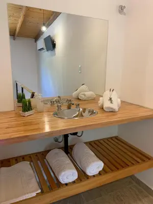 a bathroom with a sink and a mirror at Aromas del Valle in Santa Rosa de Calamuchita