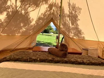 a large tent with a rug in front of it at GLAMPING RANCHO ALEGRE in Merlo