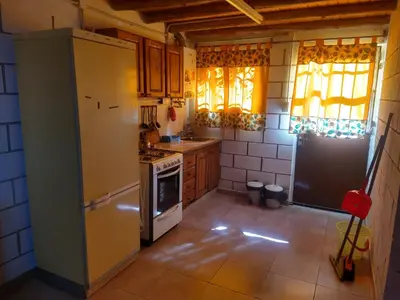a kitchen with a refrigerator and a stove at Cabañas Rio y Playa in Atos Pampa