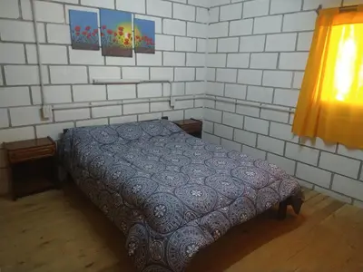 a small bedroom with a bed in a room at Cabañas Rio y Playa in Atos Pampa