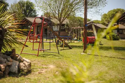a park with a playground with a swing set at Aldea Alentue in Santa Rosa de Calamuchita