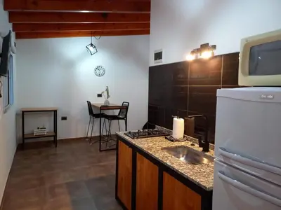 a kitchen with a sink and a counter top at Departamento 2448 in Mina Clavero