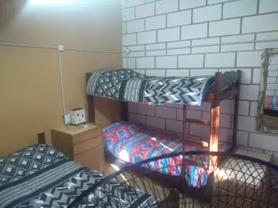 a dorm room with two bunk beds in it at cabañas rio y playa 2 in Atos Pampa