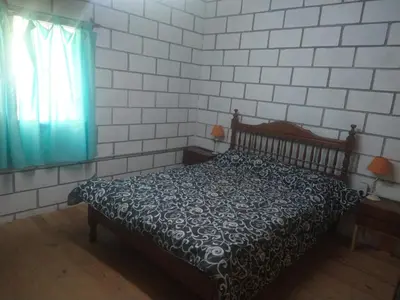 a bedroom with a bed and a window at cabañas rio y playa 2 in Atos Pampa