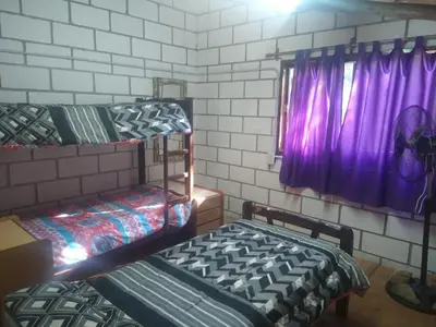 a room with two bunk beds and a window at cabañas rio y playa 2 in Atos Pampa