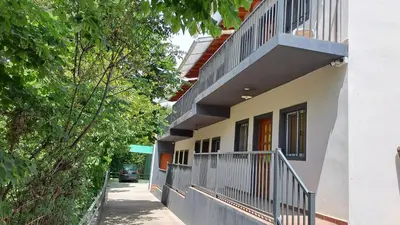 a building with balconies on the side of it at DTOS Villa del Lago in Villa Carlos Paz
