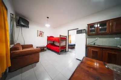 a living room with a couch and a refrigerator at DTOS Villa del Lago in Villa Carlos Paz
