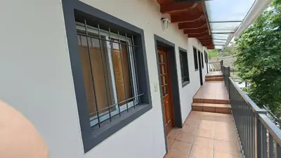 a hallway of a house with windows and a balcony at DTOS Villa del Lago in Villa Carlos Paz