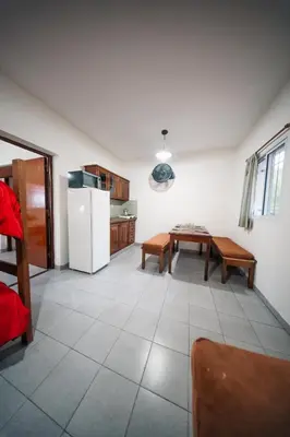 a kitchen with a white refrigerator and a table at DTOS Villa del Lago in Villa Carlos Paz