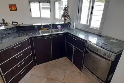 a kitchen with a sink and a stove at Casa con vista a las sierras in Santa María