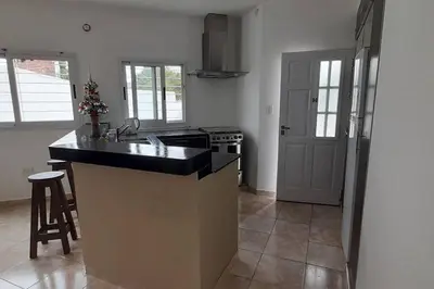 a kitchen with a counter and a stove top oven at Casa con vista a las sierras in Santa María