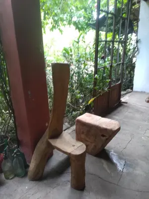 a wooden bench sitting next to a building at Casa alma verde alegría y paz in Luyaba
