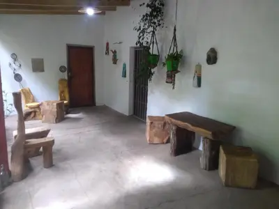 a room with wooden benches and plants on the wall at Casa alma verde alegría y paz in Luyaba