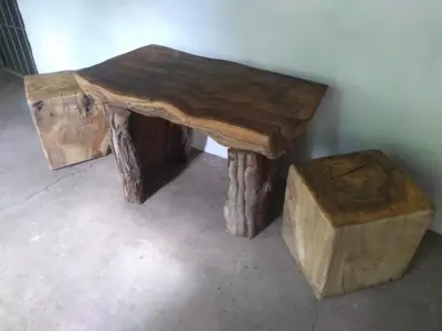 a wooden table with a stool and a table made out of logs at Casa alma verde alegría y paz in Luyaba
