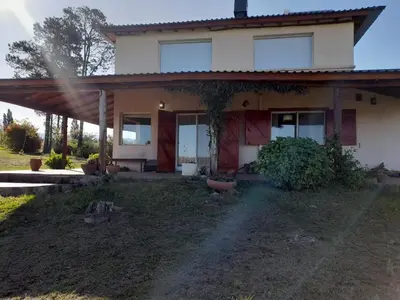 a house with a large yard in front of it at Sol Mayor in Villa Yacanto