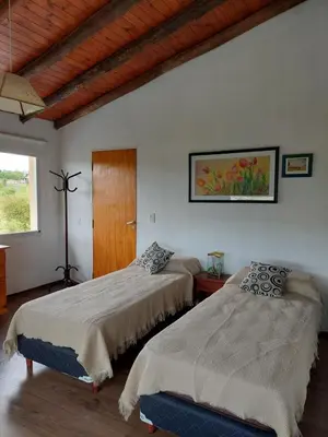 a bedroom with two beds and a window at Sol Mayor in Villa Yacanto