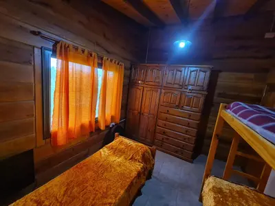 a room with a bed and a window in a cabin at CABAÑA PRIVADA NALÚ in Villa Ciudad Parque