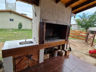 an outdoor kitchen with a sink and a stove at CABAÑA PRIVADA NALÚ in Villa Ciudad Parque