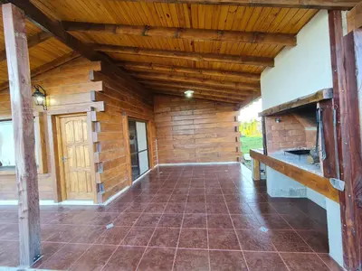 an empty porch of a log cabin with a wooden ceiling at CABAÑA PRIVADA NALÚ in Villa Ciudad Parque